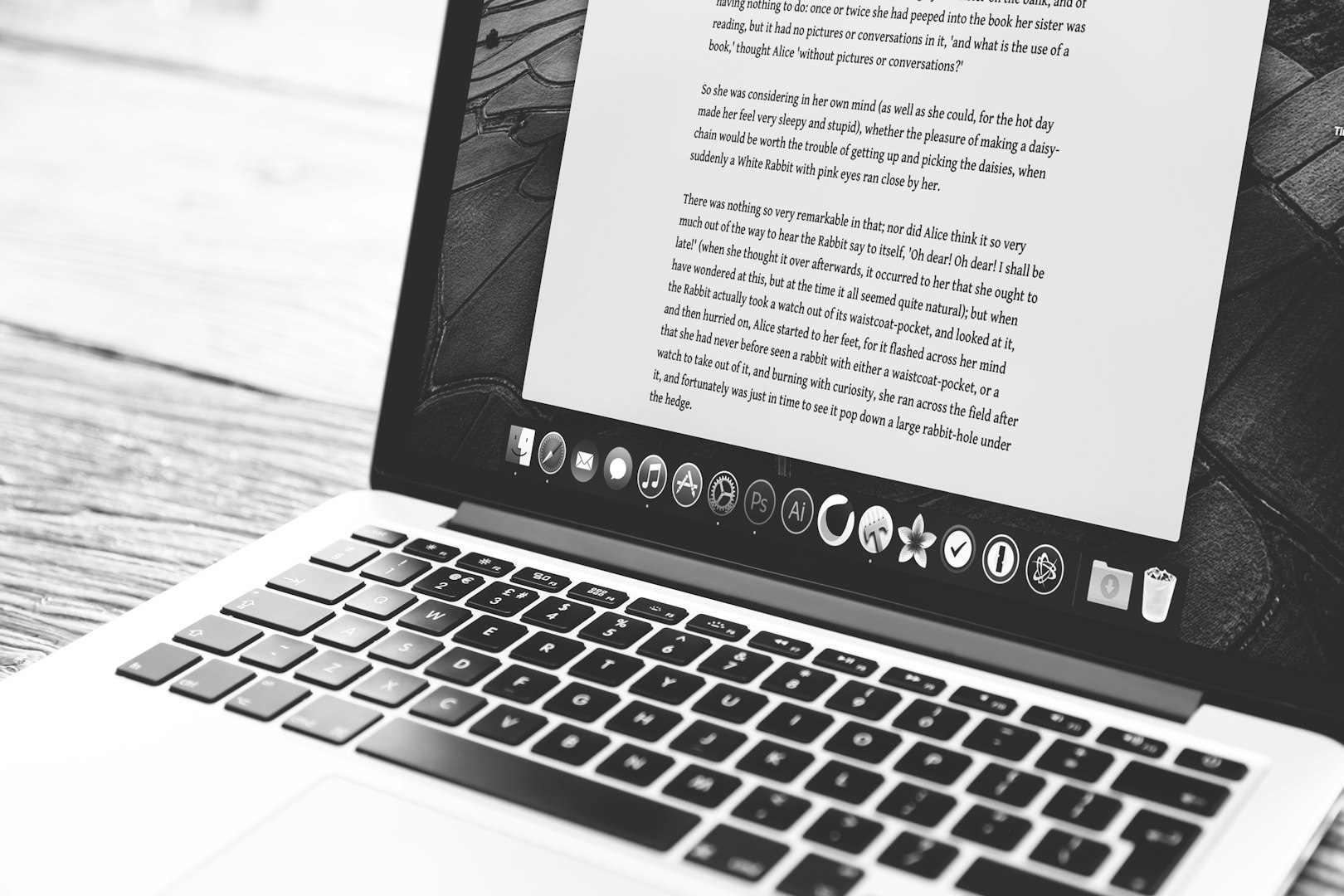 Black and white image of SEO content being created on a mac book