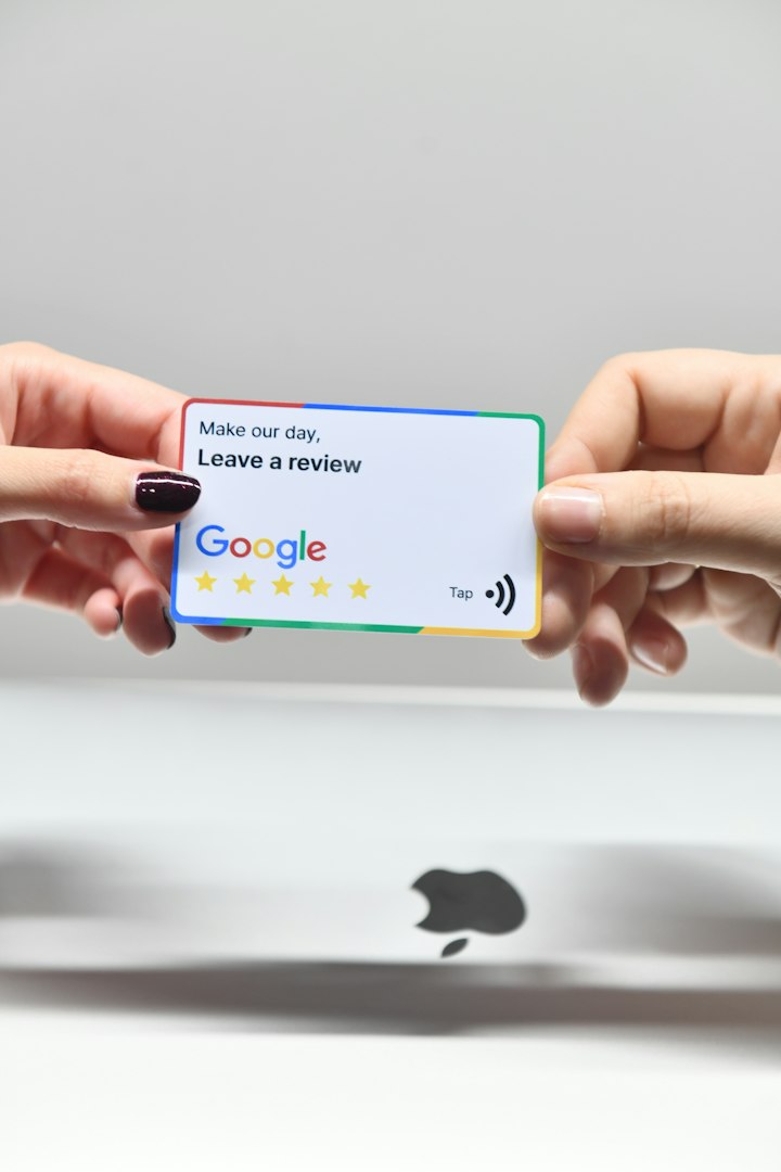 2 hands holding a tap to review card saying make our day leave us a review