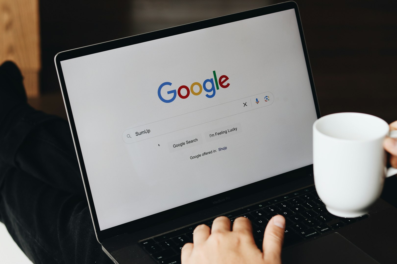 black laptop open on Google homepage