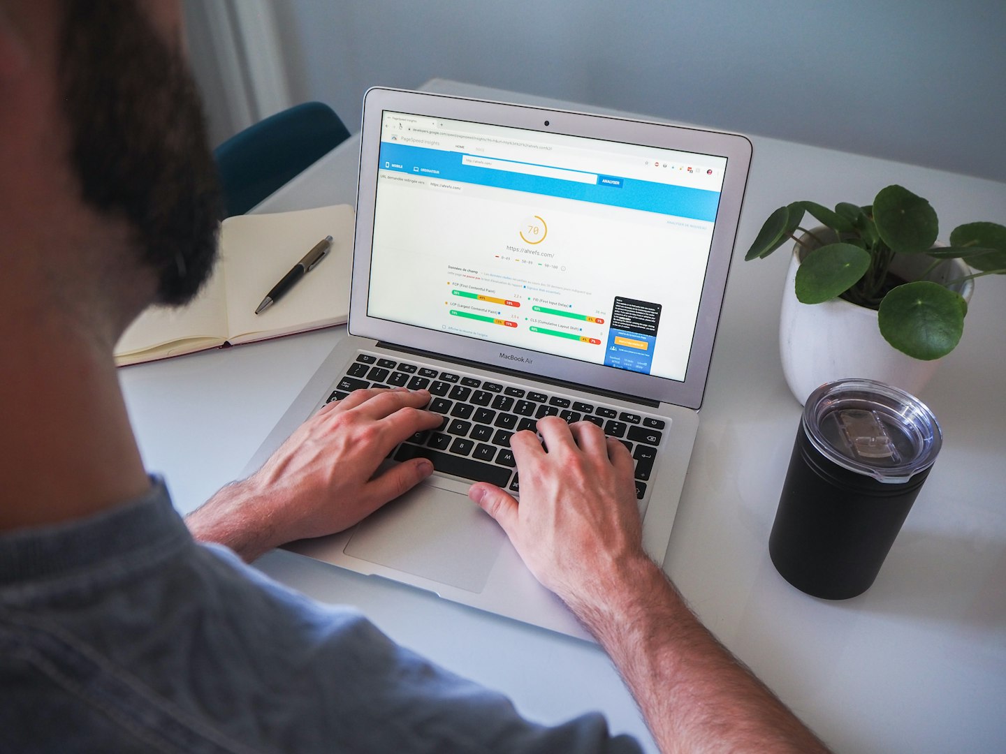 hands touching laptop doing seo work for locksmiths with screen showing website analysis  
